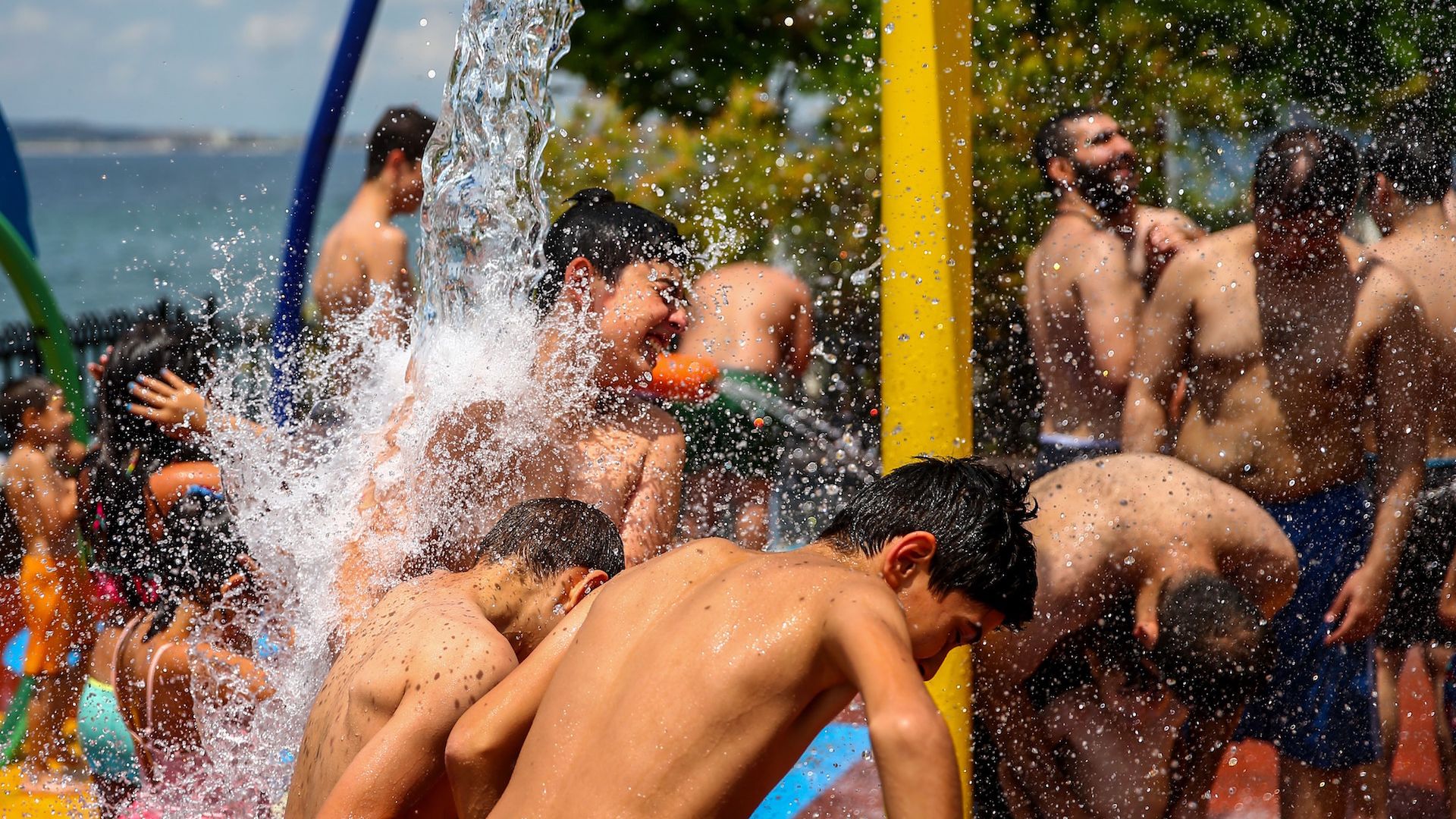 ISTANBUL, TUKEY - JULY 8: People enjoy the water in an attempt to cool of as the heatwave continues at Gurpinar Public Beach, in Istanbul, Turkey on July 8, 2018.