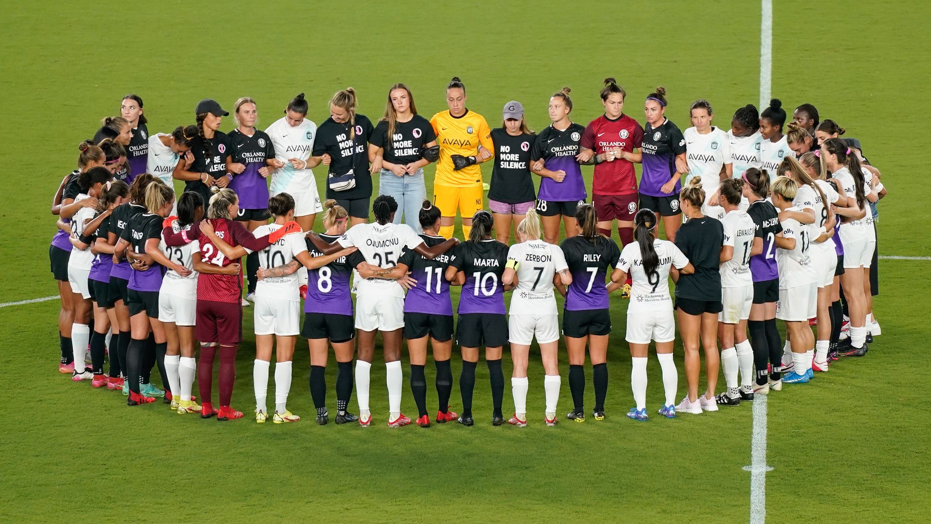 NWSL players linking arms in solidarity