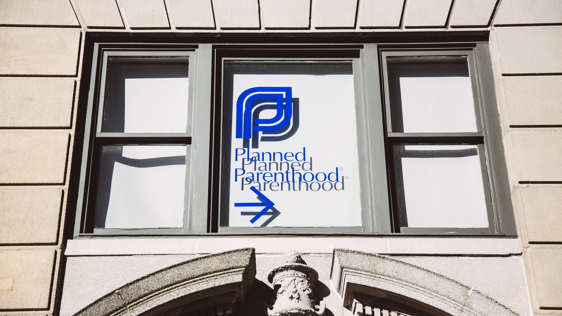 In this image, the Planned Parenthood logo is seen in a window