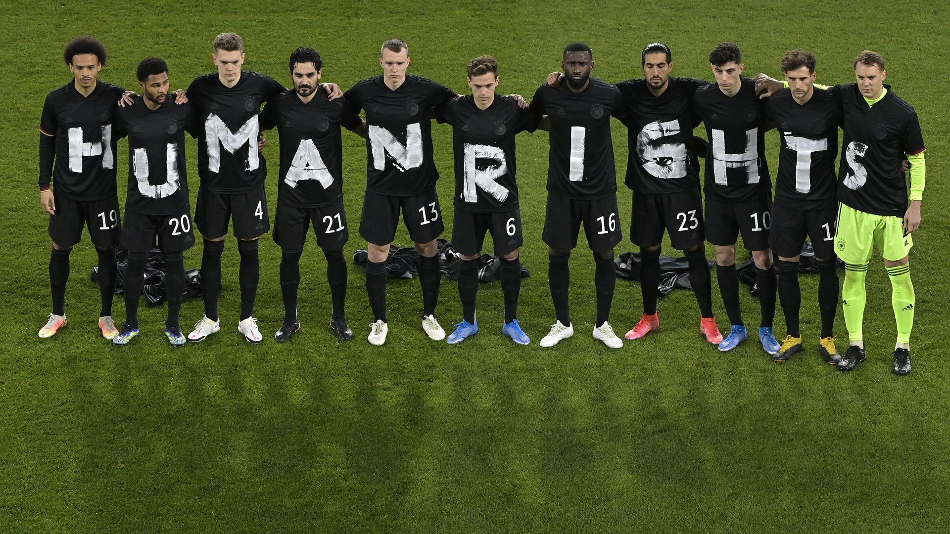 Players spell out human rights on their shirts.