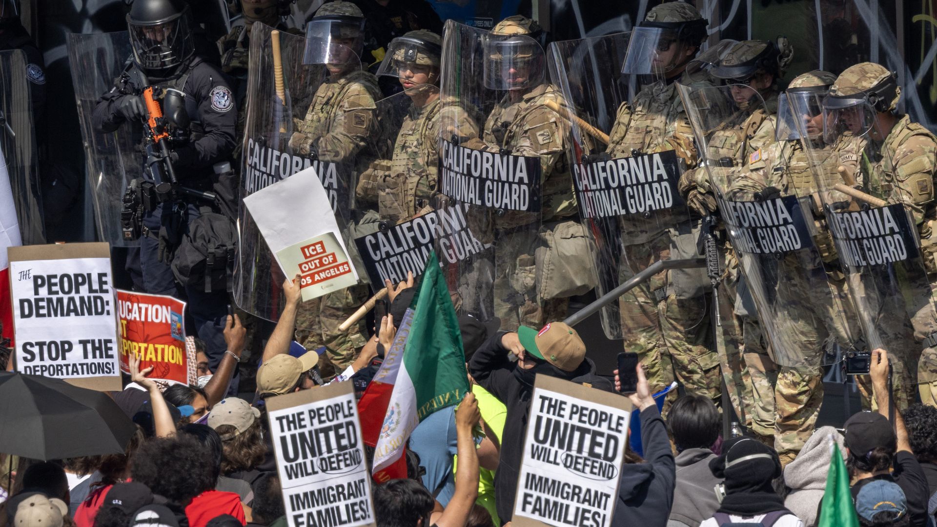 Protesters rally next to the California National Guard