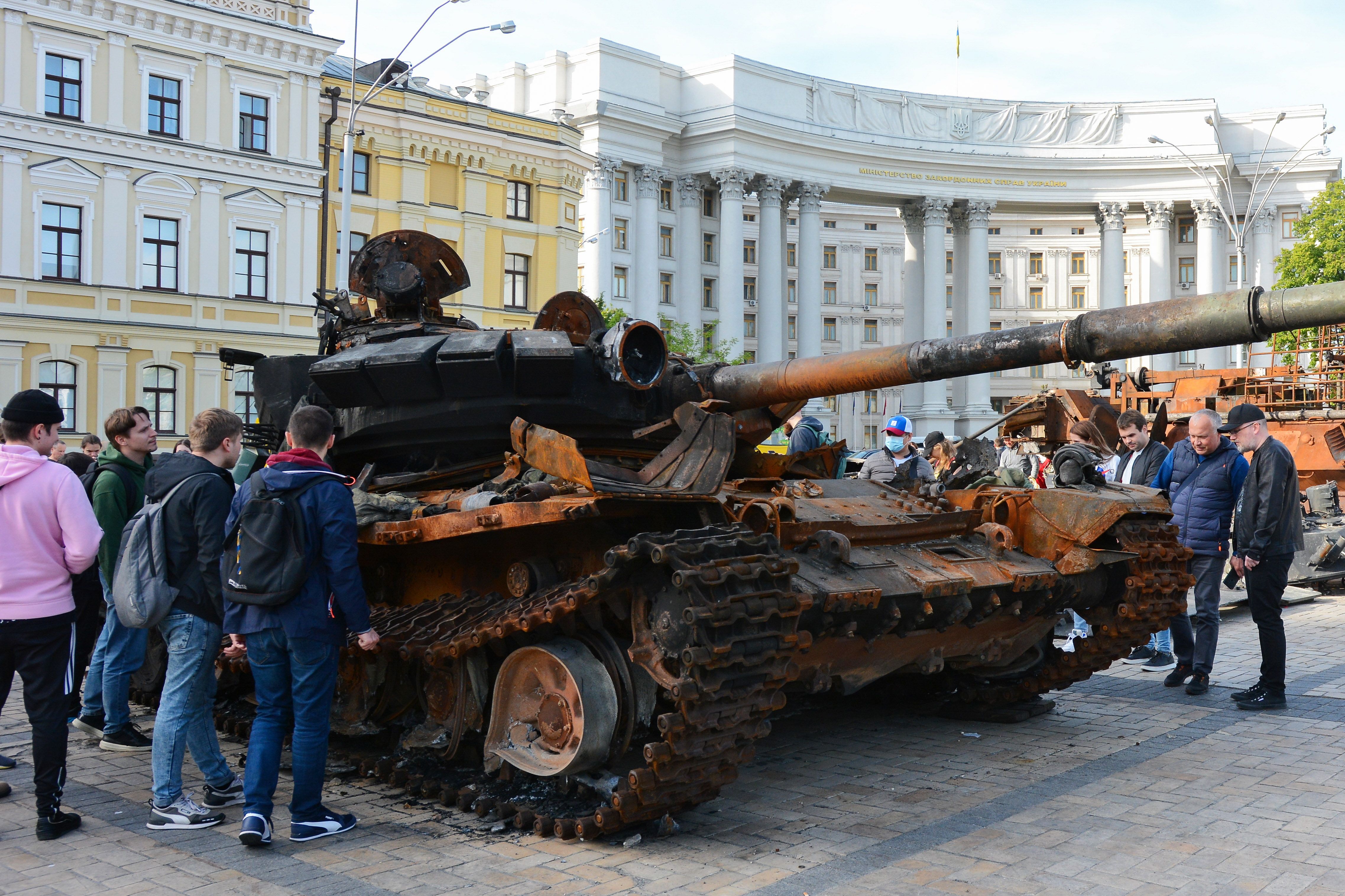 People looking at a Russian tank displayed at Mykhailivska Square in Kyiv on May 23.