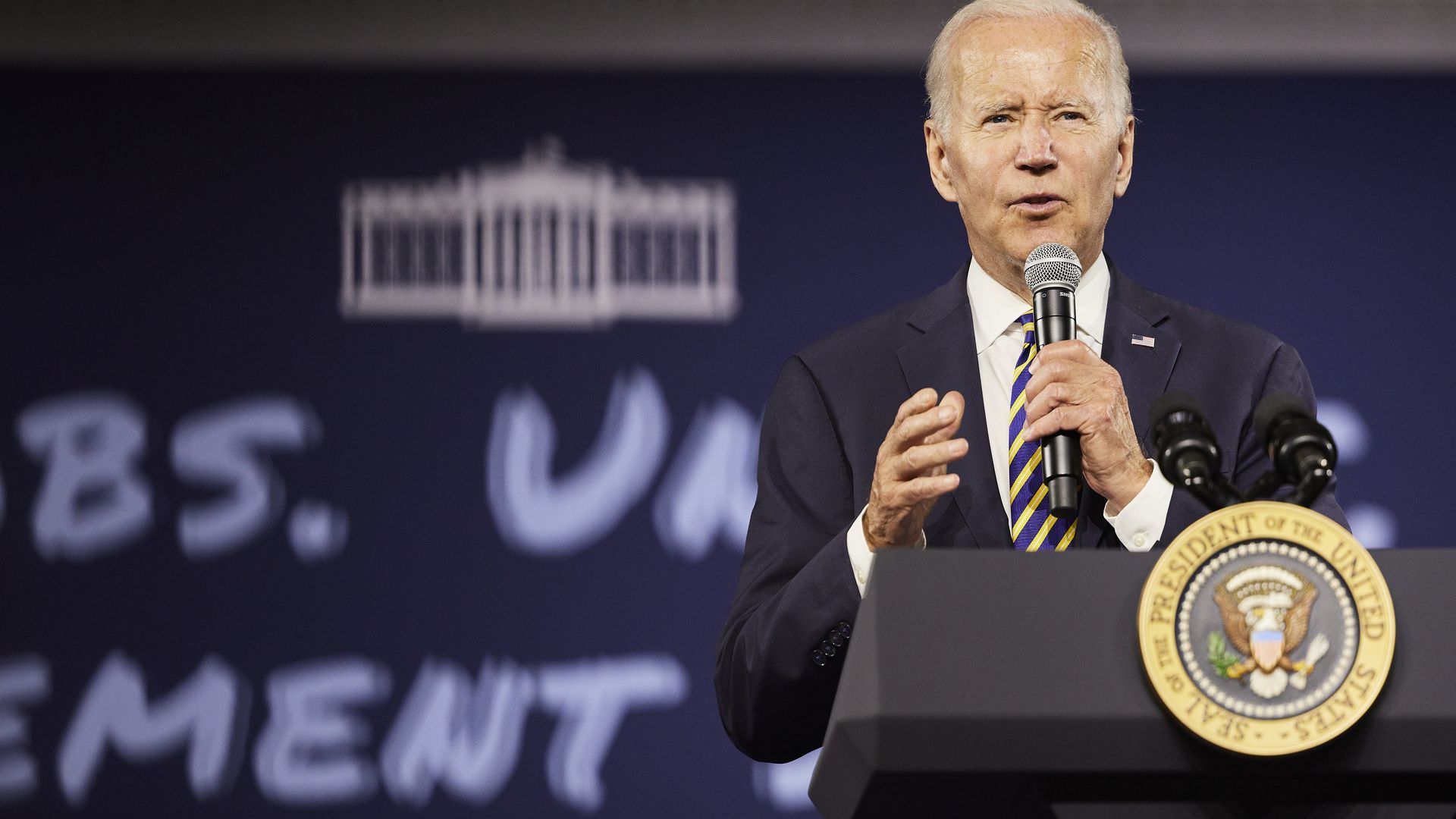 Joe Biden speaks at a presidential lectern.