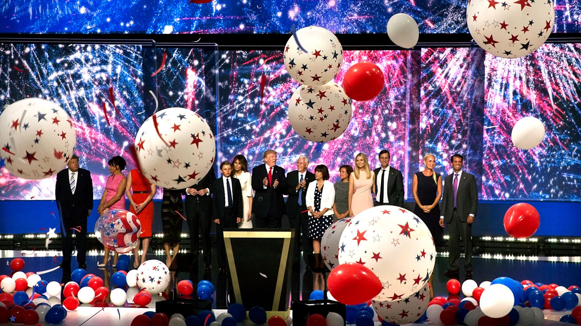 Donald Trump (center, in red tie) and Mike Pence (center right, in blue tie), and their families on the final night of the Republican National Convention in 2016