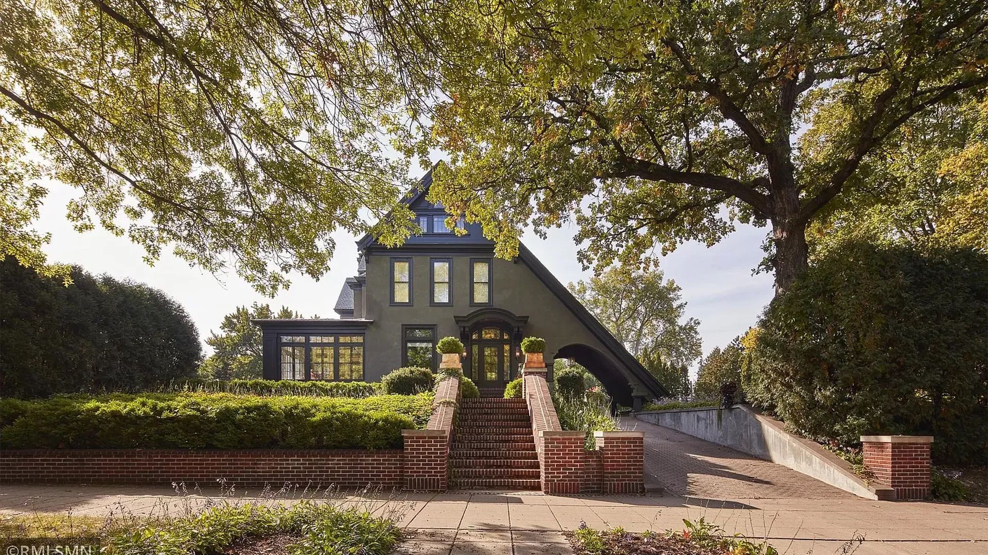 A green house with a sliding roof on a summer day.
