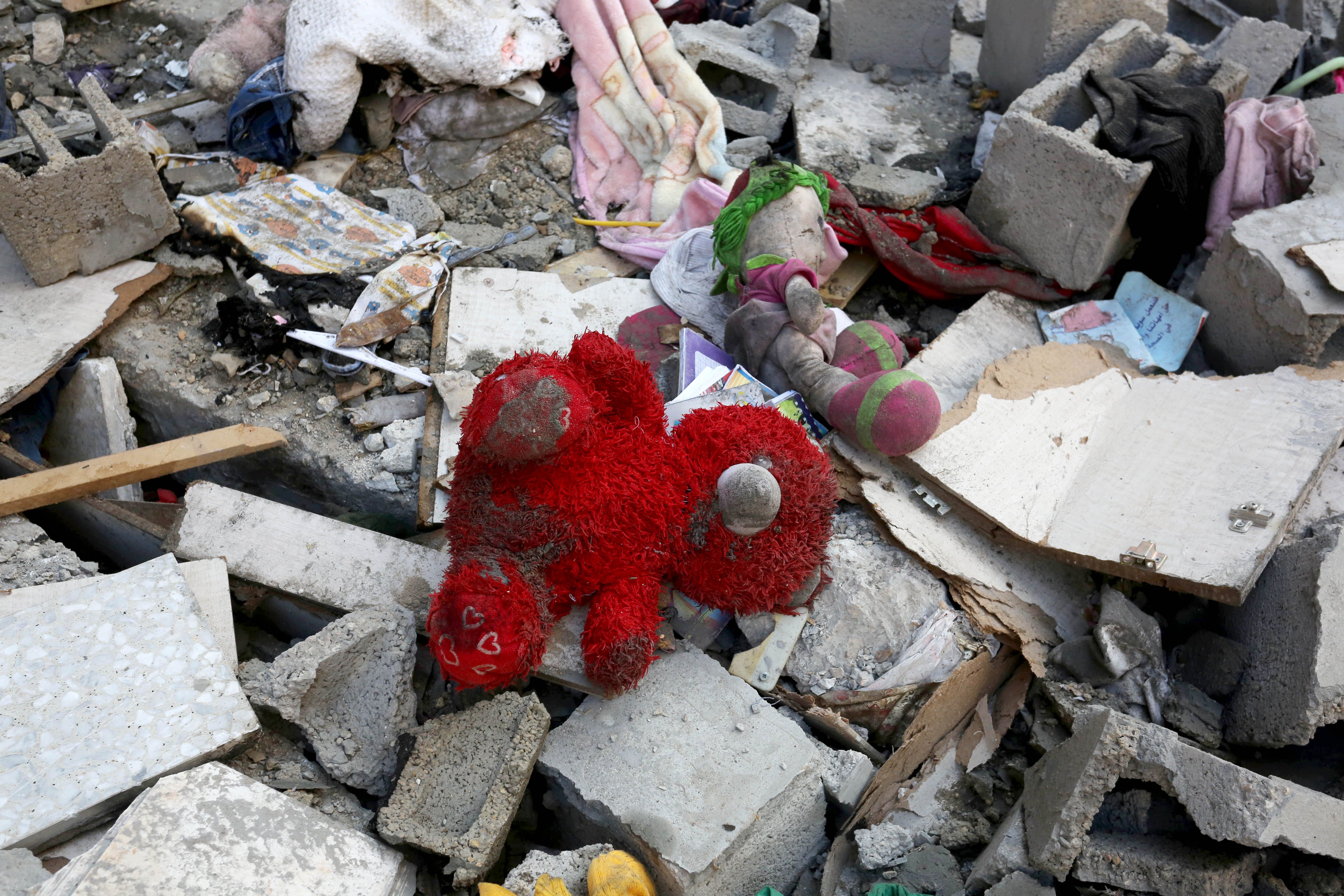 A red teddy bear in the remains of a destroyed building in Gaza.