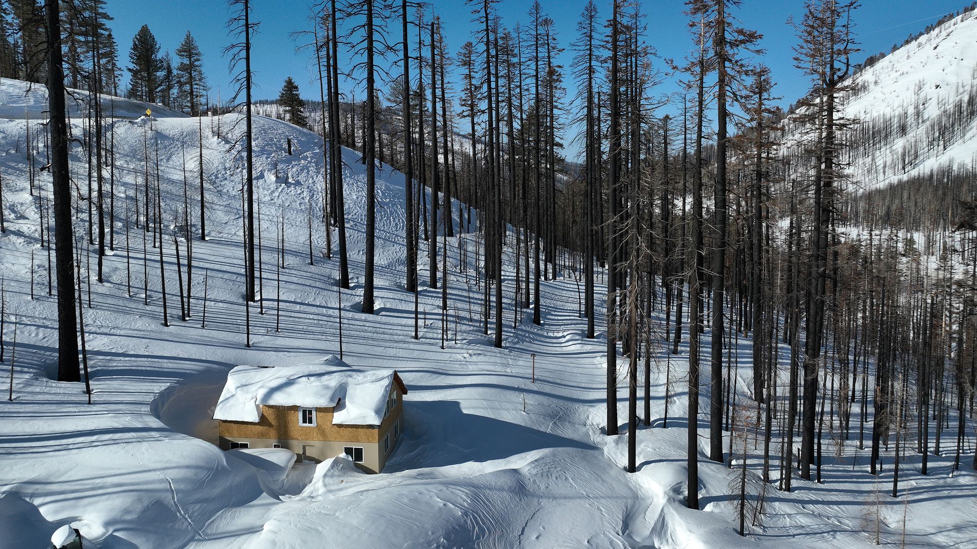 Aerial view of home covered in snow in Twin Bridges, CA