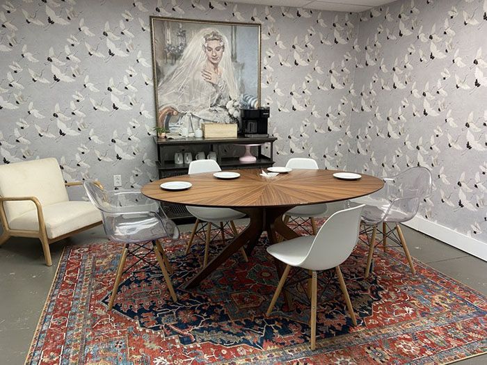 The tasting room. The antique portrait hanging on the wall from Sleepy Poet adds a touch of nostalgia.