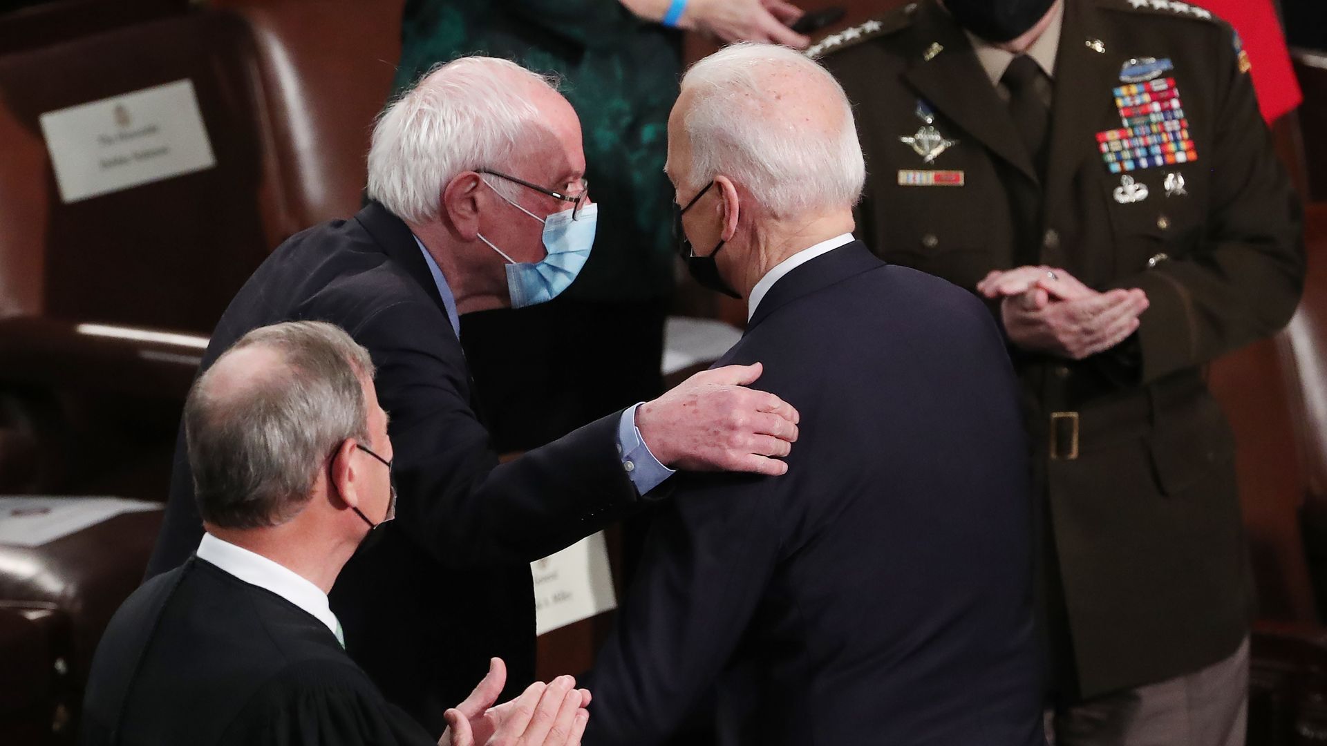 President Biden and Senator Bernie Sanders talk on the House floor before Biden's address to a joint session of Congress