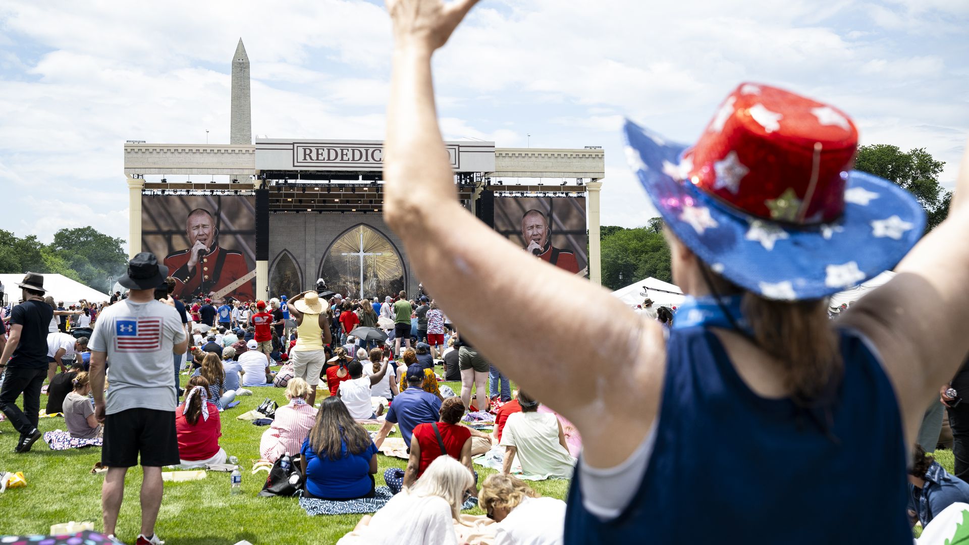 Attendees listen to a military band on stage during Rededicate 250: A National Jubilee of Prayer, Praise and Thanksgiving, on the National Mall, on May 17, 2026, in Washington, DC. Leading up to the America 250 celebration later in the year, thousands gathered on the Mall for a day of scripture.