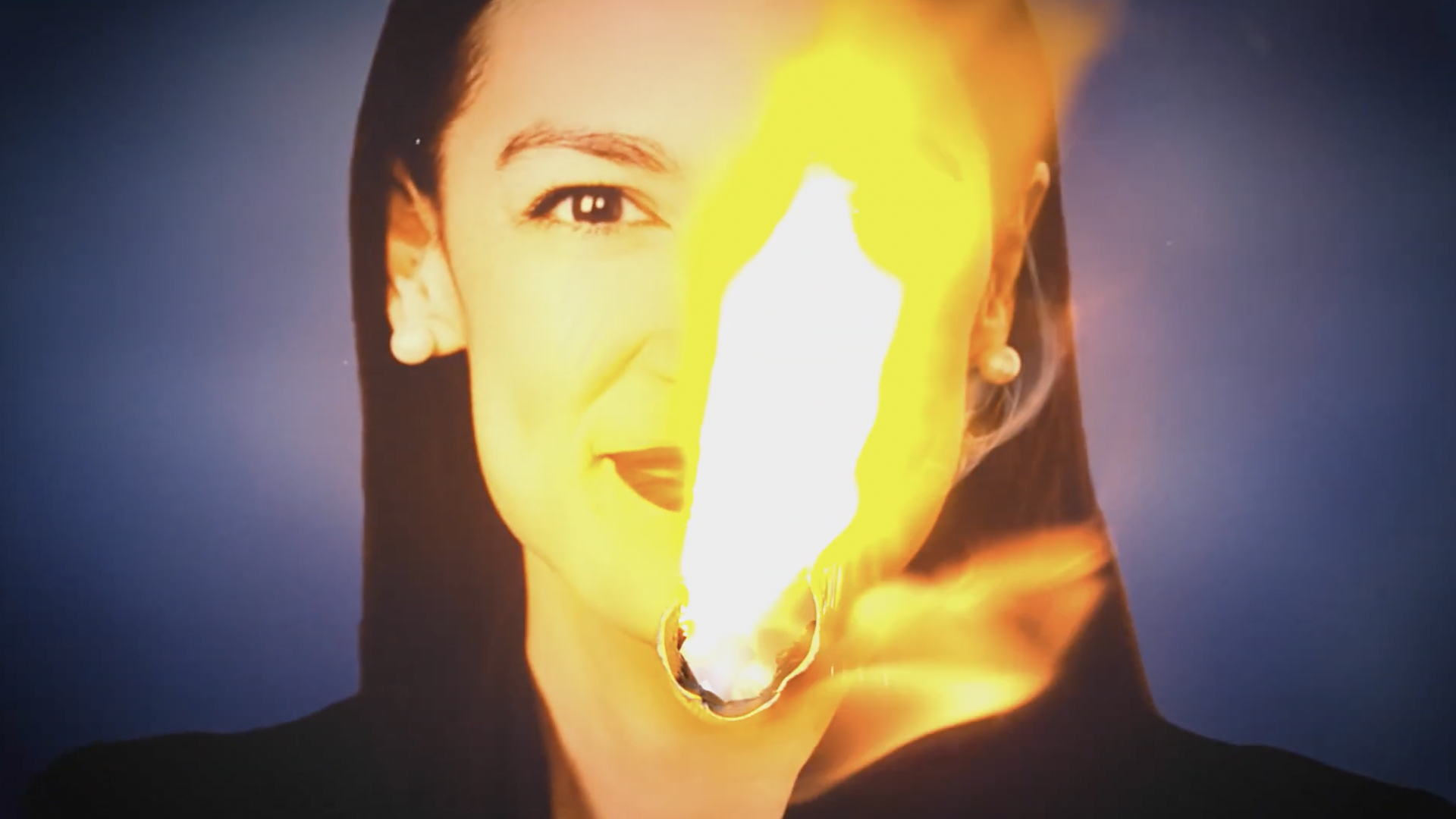 A screenshot from a Republican political ad showing a photo of Rep. Alexandria Ocasio-Cortez in flames.