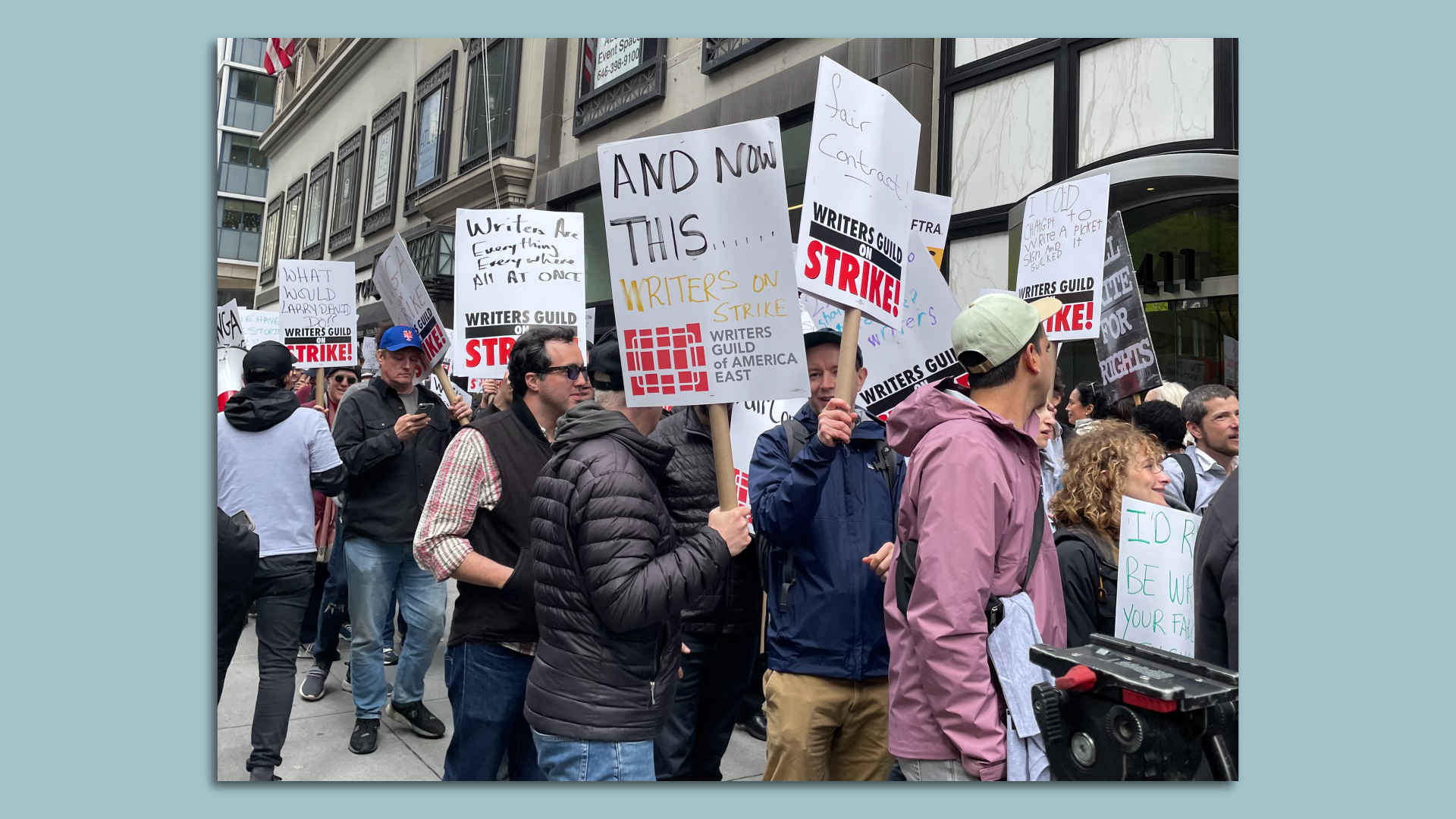 Writers Guild of America members holding picket signs outside of Peacock NewFront event in midtown Manhattan