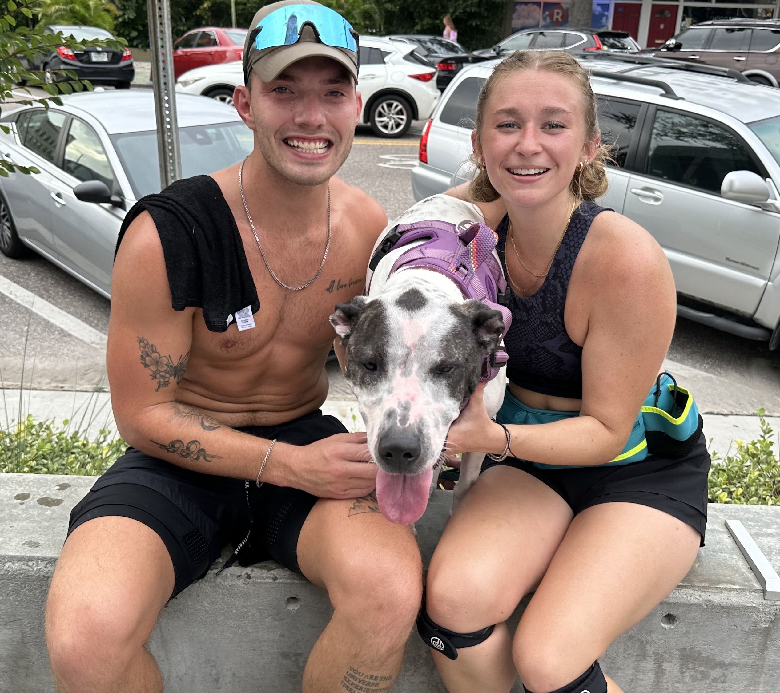 man, woman and dog pose for photo
