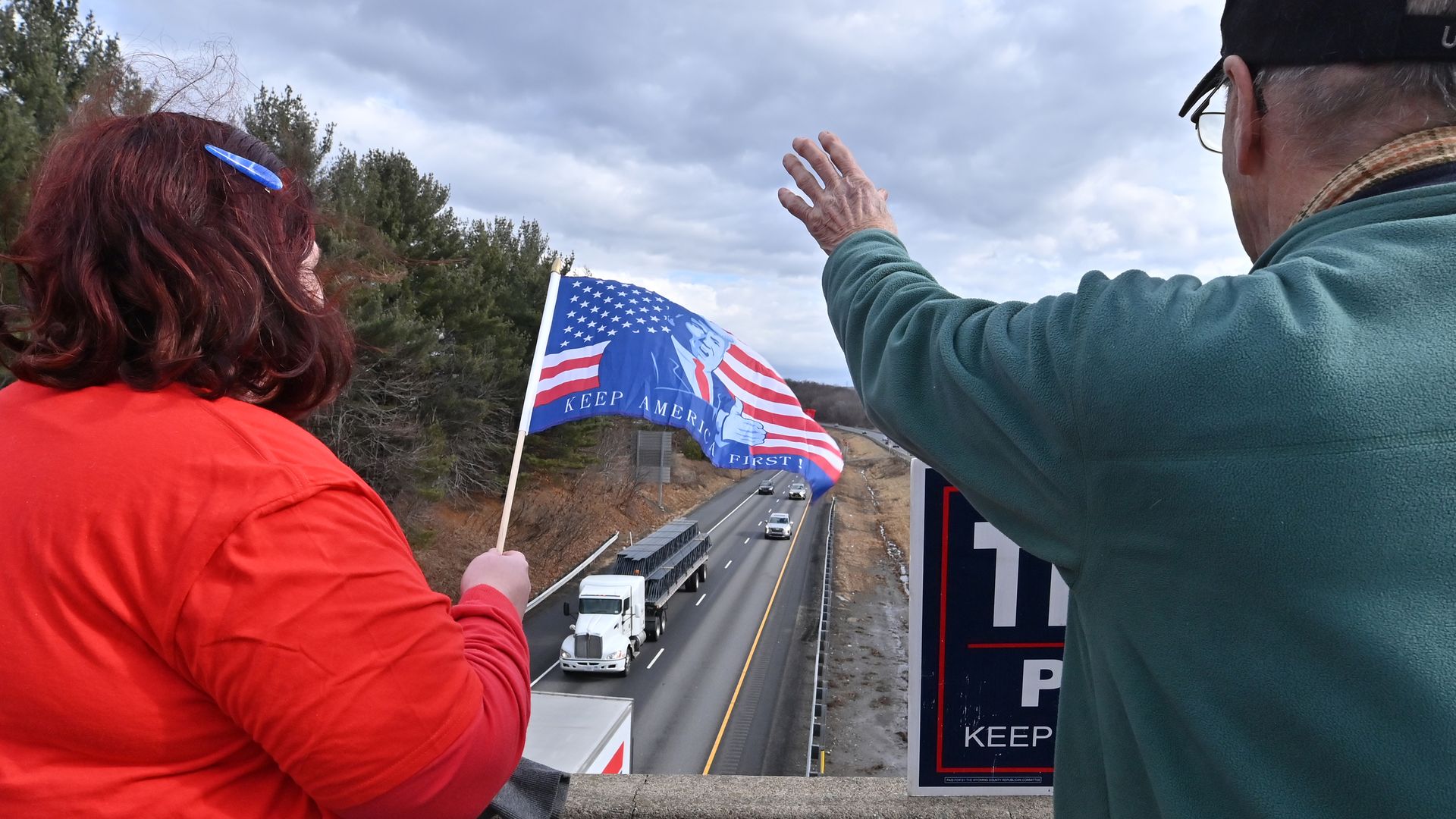 Supporters wave as the anti-vaccine mandate trucker's convoy heads toward Washington.