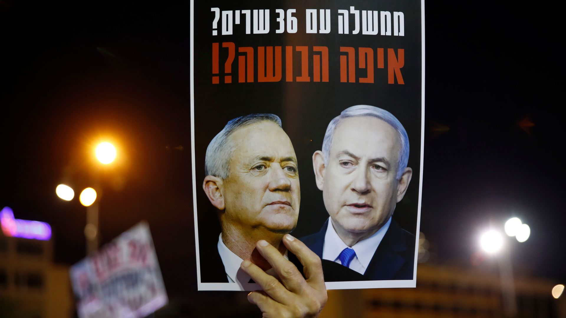Protestor holding picture of Netanyahu and Gantz