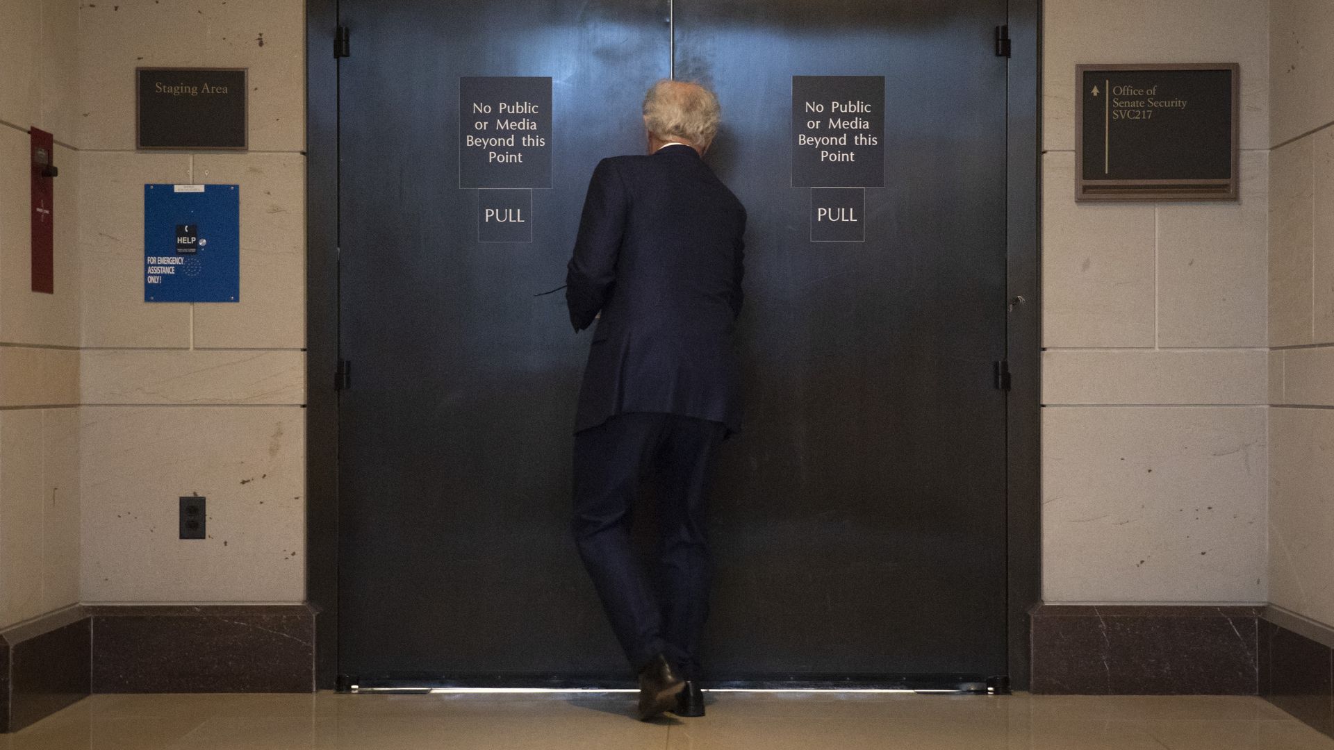 Senator Bob Corkers enters a room labeled "No Public or Media Beyond This Point," where senators reviewed the FBI report on Kavanaugh