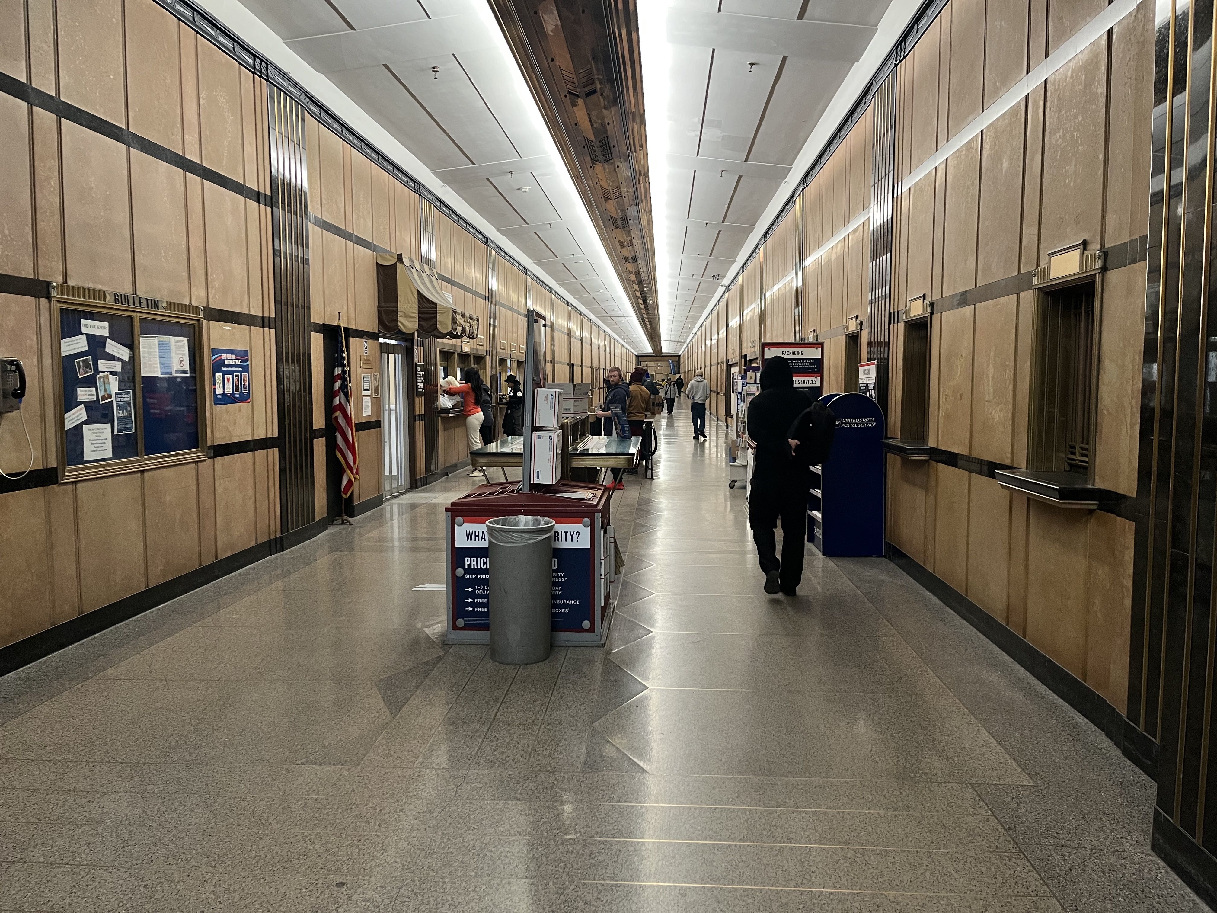 The inside of the post office with people mailing packages 