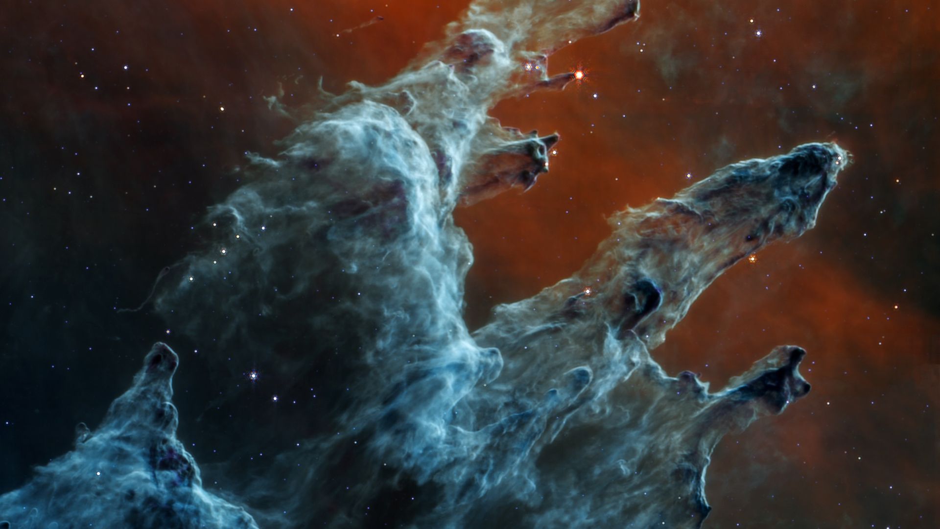 The Pillars of Creation. Towers of blue dust and gas stretch light-years into space