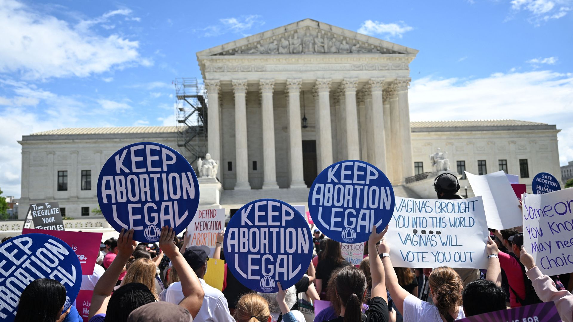 Picture of an abortion rights protest happening in front of the Supreme Court building. Protesters have signs that say "keep abortion legal."