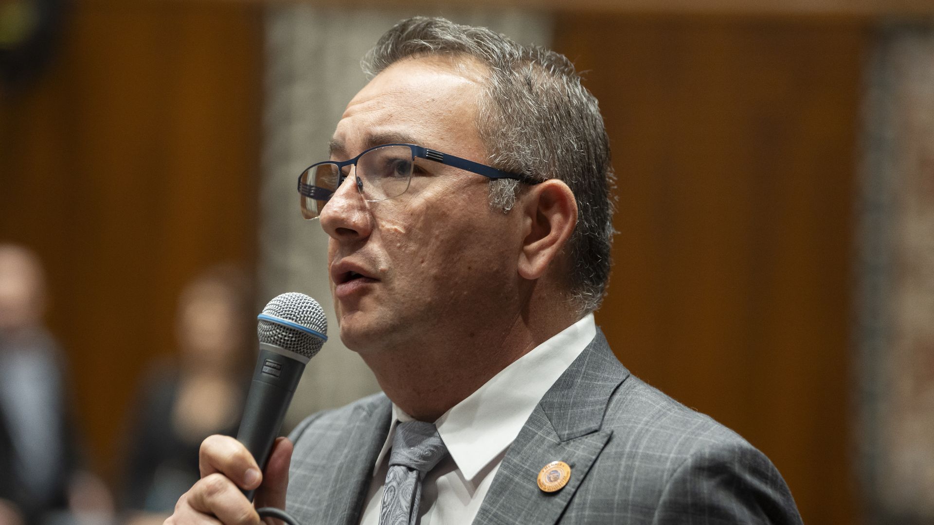Ben Toma speaks into a microphone on the floor of the Arizona House of Representatives.