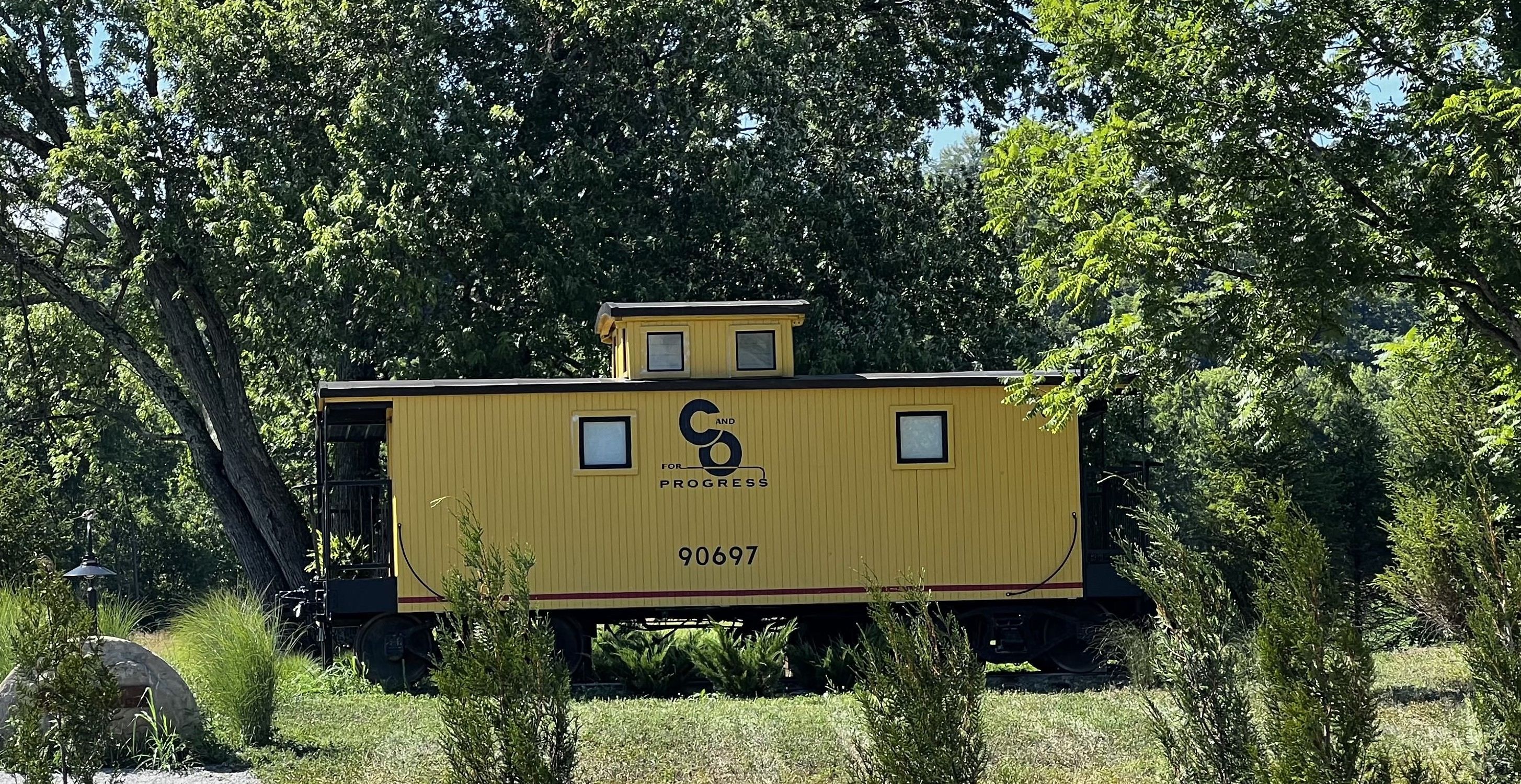A yellow cabin made from an old caboose. 