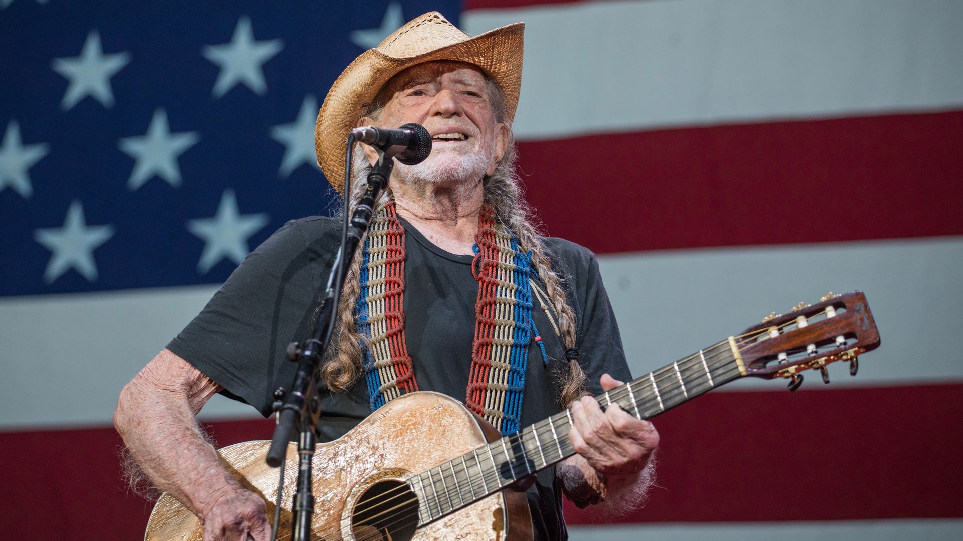 Willie Nelson in front of an American flag