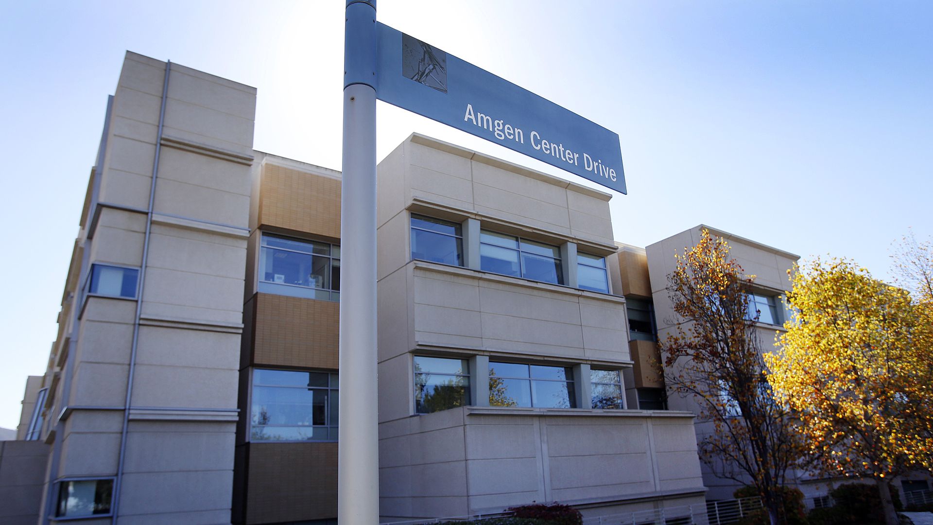 A street sign in front of a building near Amgen headquarters