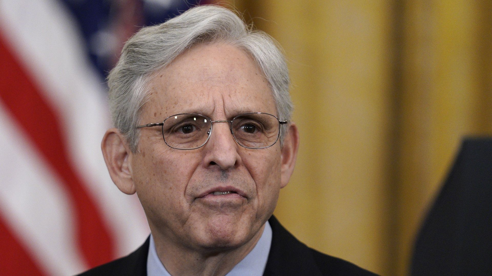 Merrick Garland wears a suit and tie