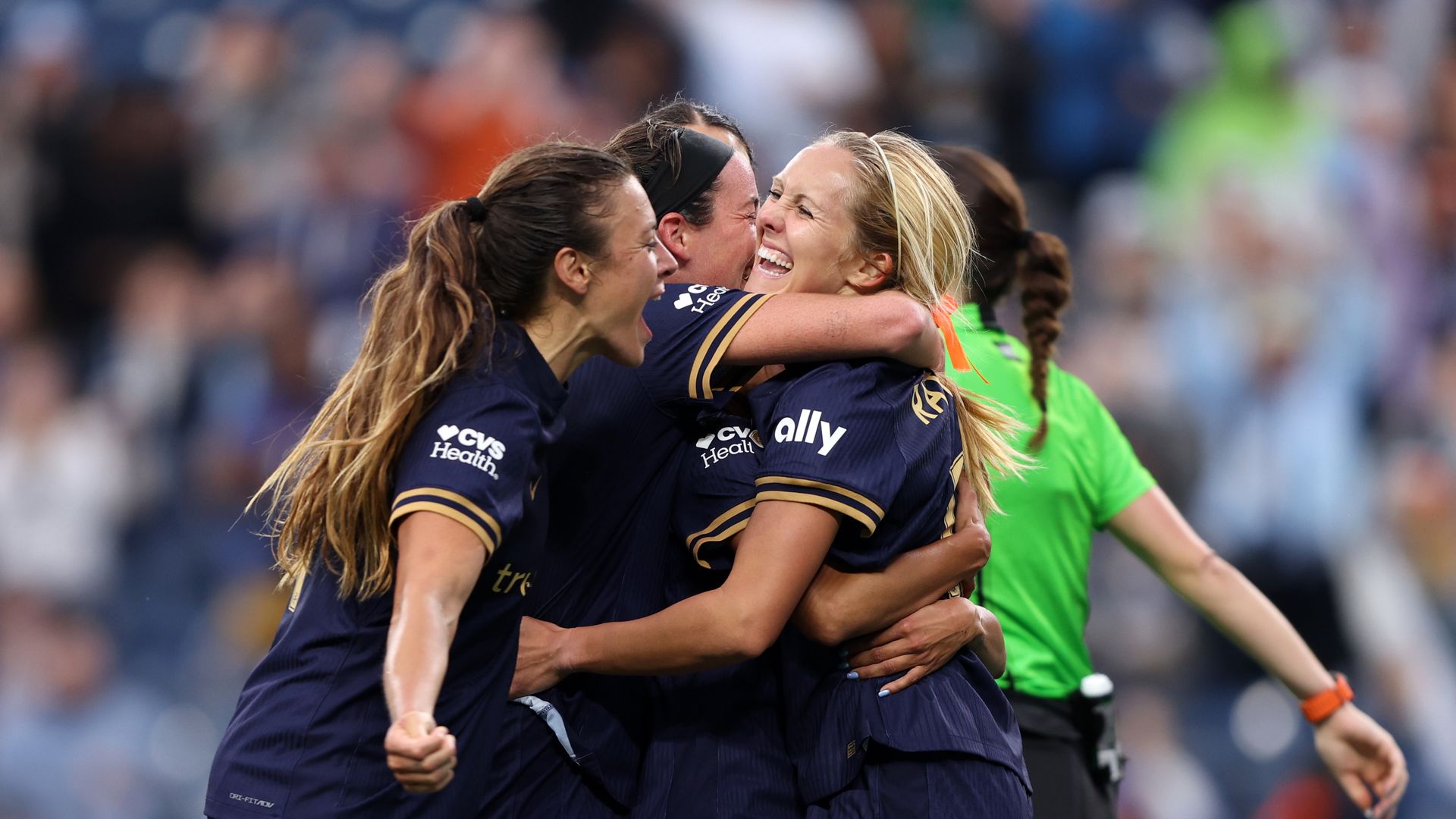 Seattle Reign players embrace and celebrate their 2-0 win over Bay FC at Lumen Field.