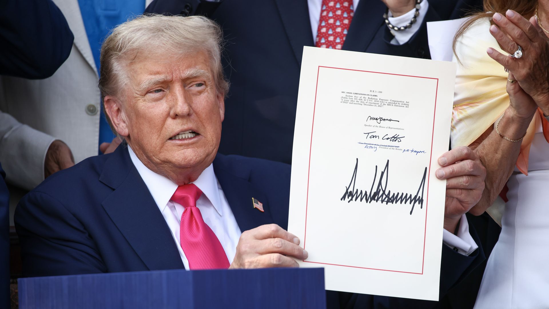 Trump holds a signed bill