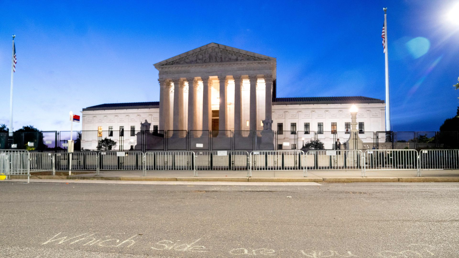 View of the Supreme Court building from the street after the sun has fallen.