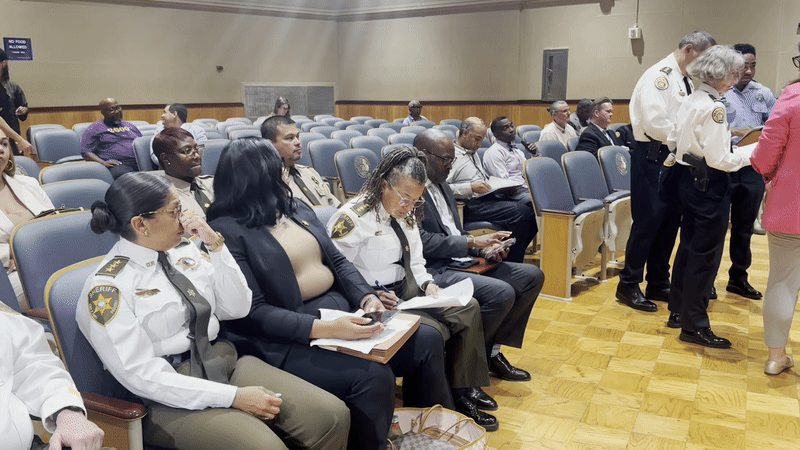 image shows law enforcement in council chambers