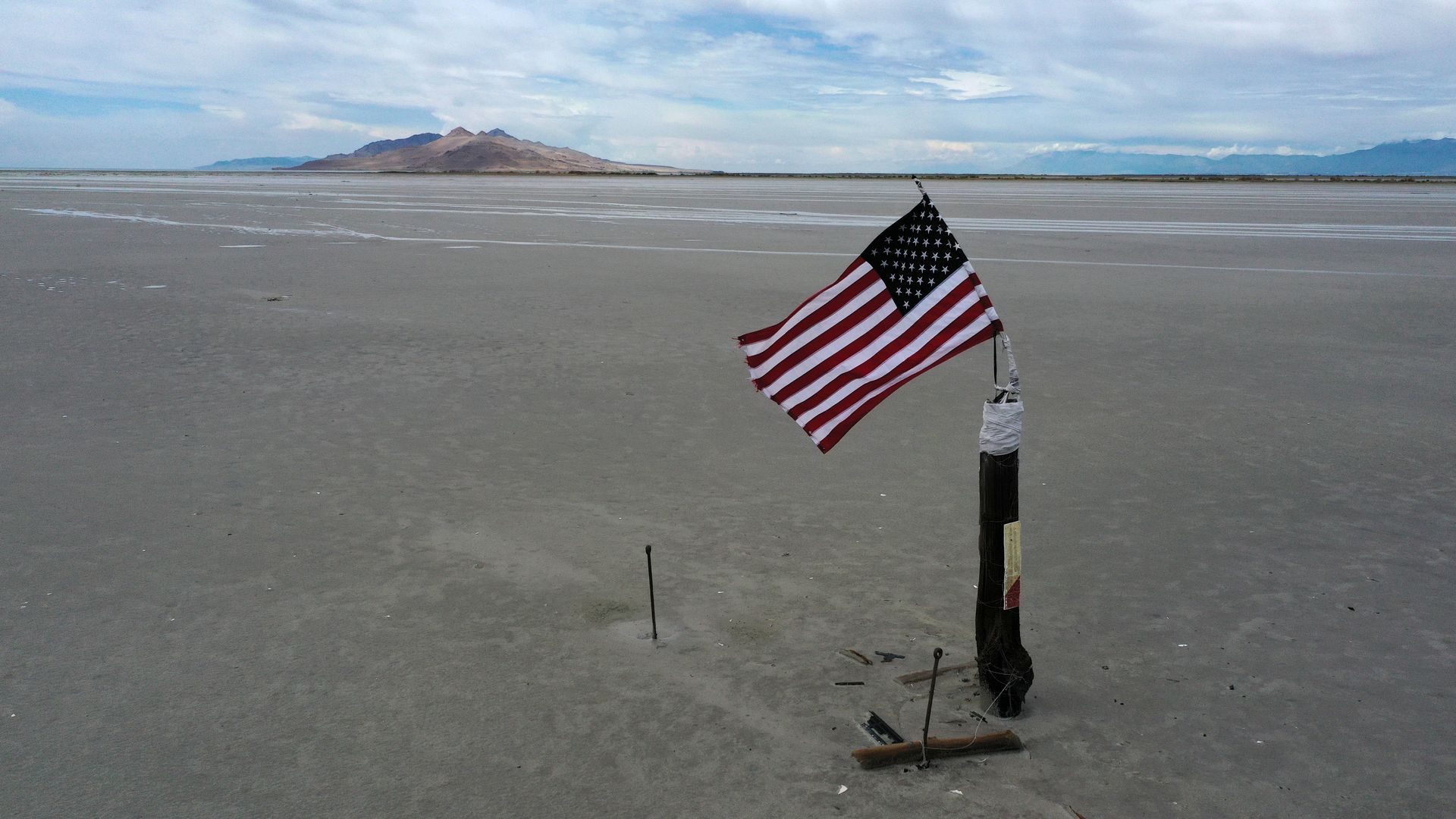 An American flag flies over a section of the Great Salt Lake that used to be underwater.