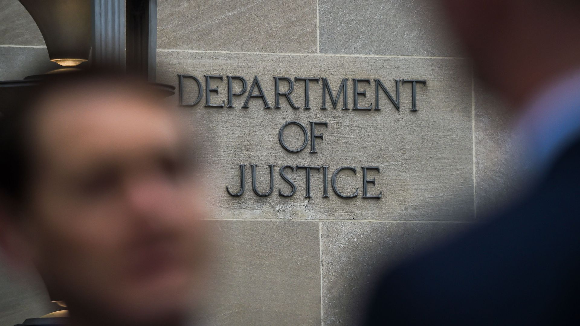 A "Department of Justice" sign is seen on the wall of the US Department of Justice building in Washington, DC on April 18, 2019. 