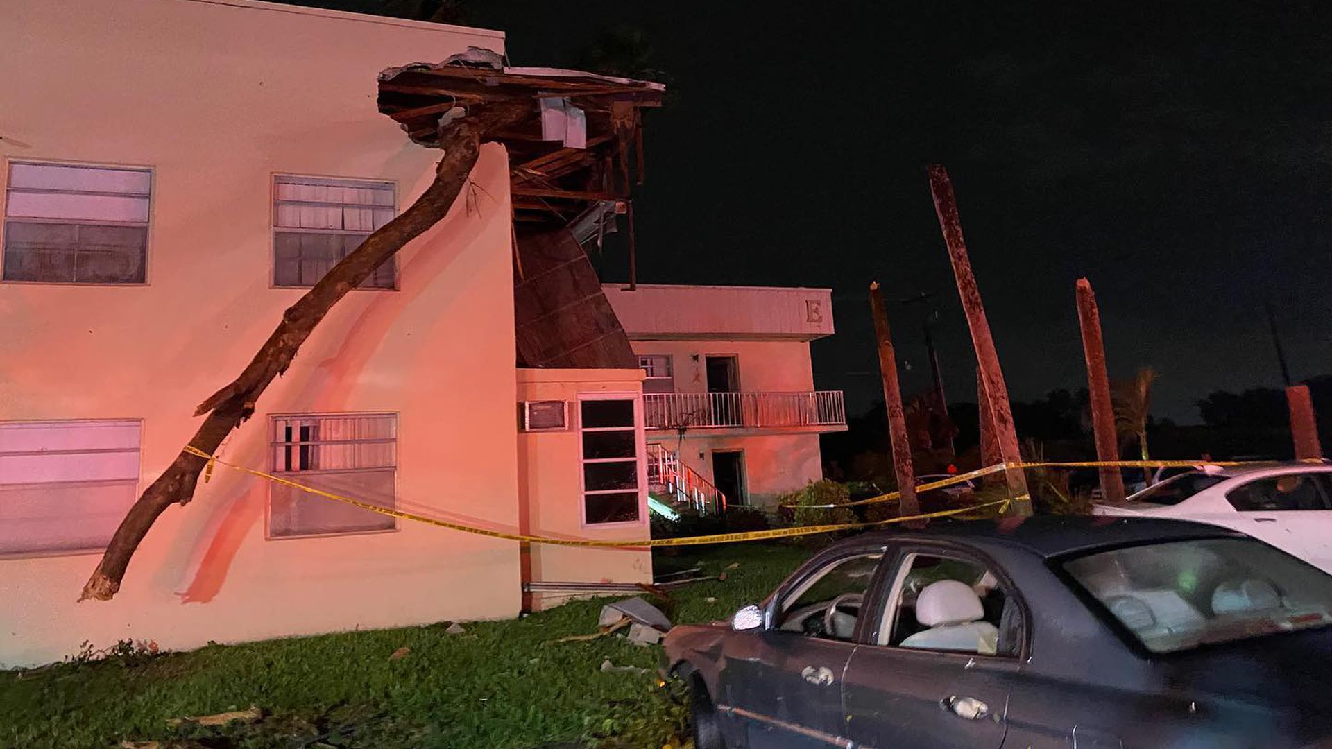 A possible tornado from Hurricane Ian's outer bands snapped a tree and blew it into a building in Delray Beach on Tuesday. 
