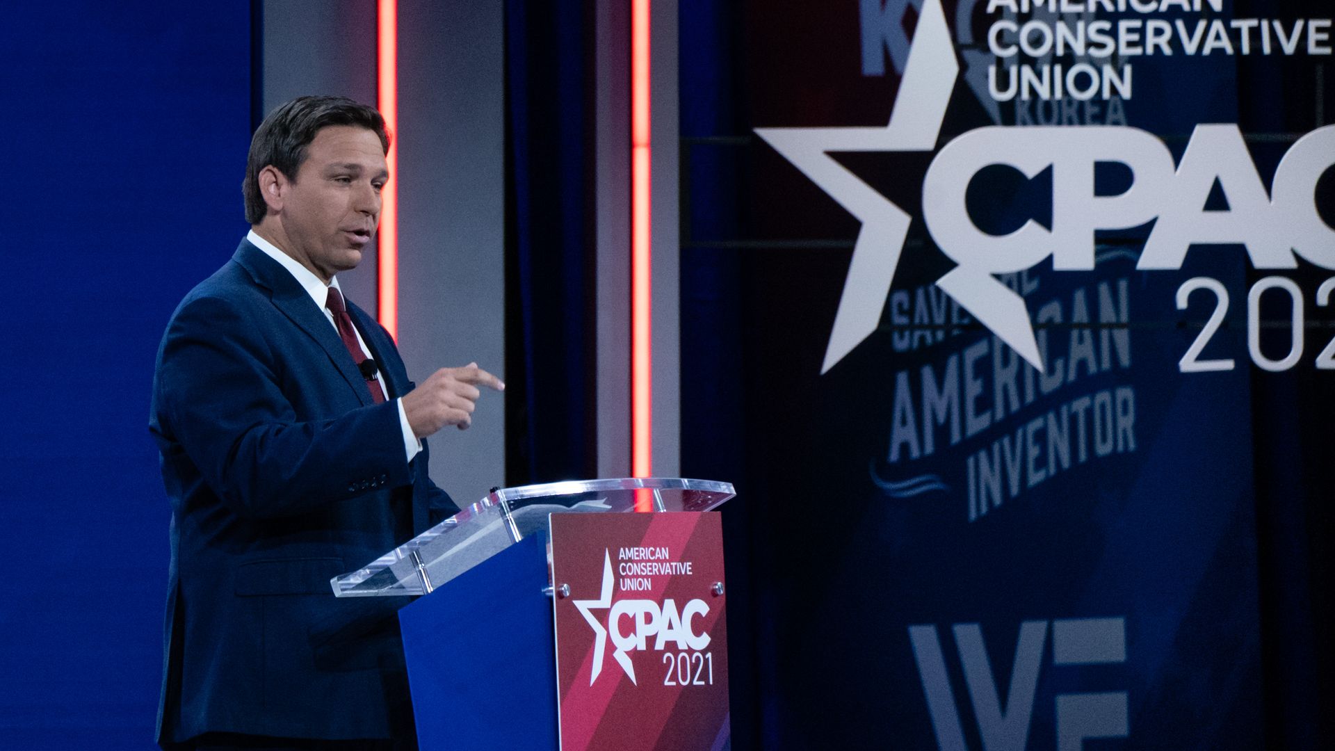 Florida Gov. Ron DeSantis stands at a podium and speaks.