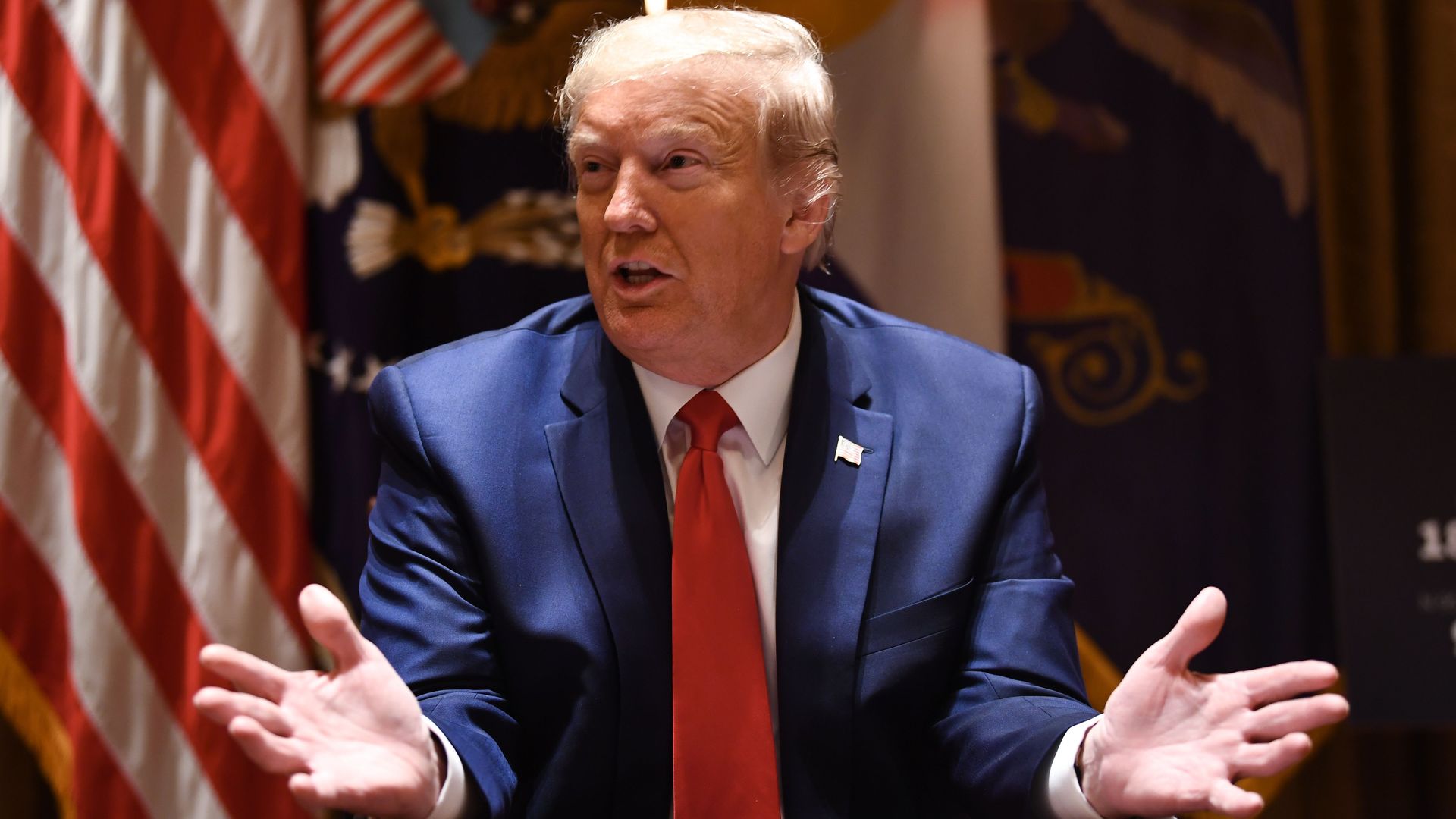 In this image, President Trump sits