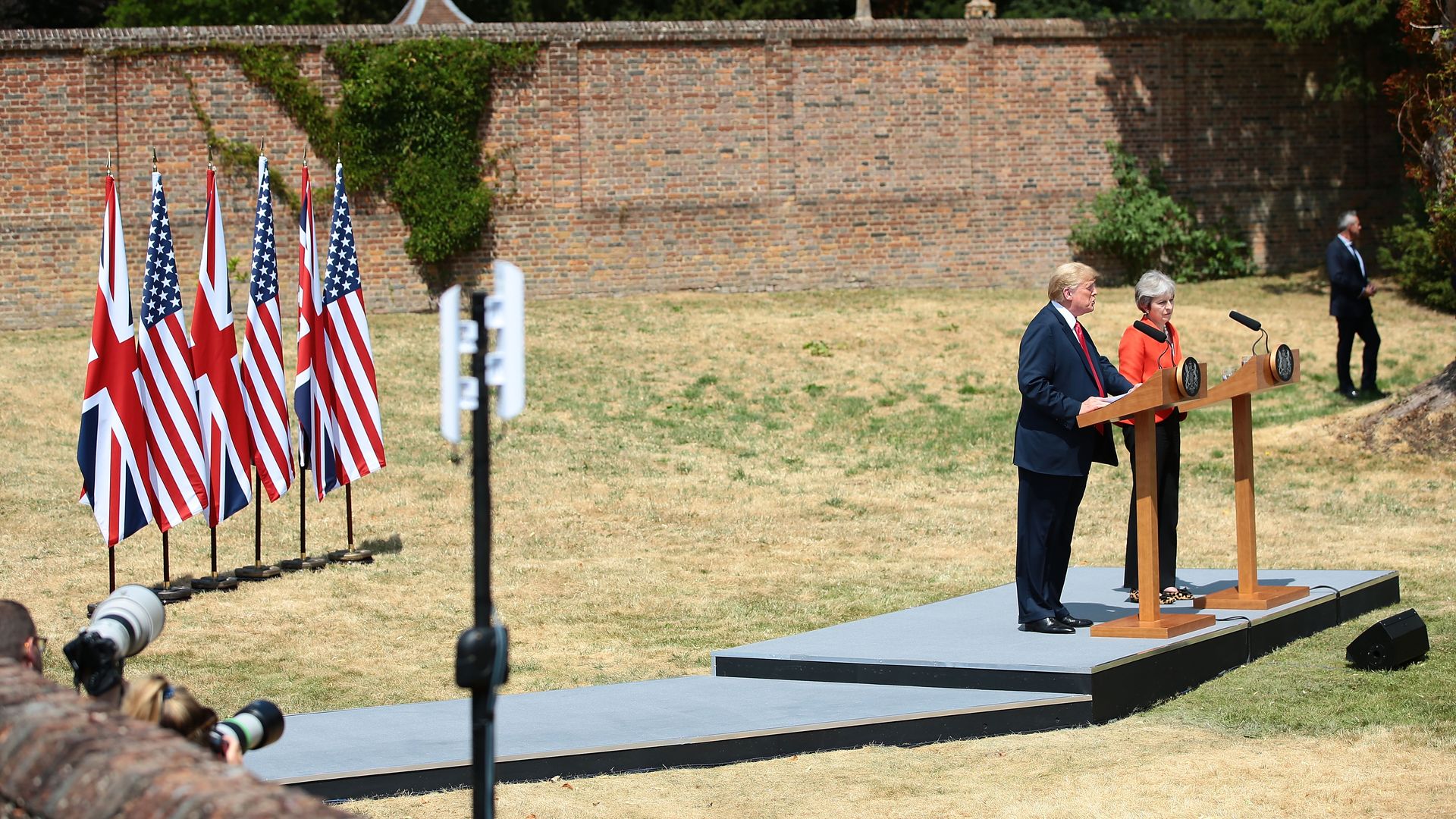 Theresa May and Trump speak behind their respective podiums