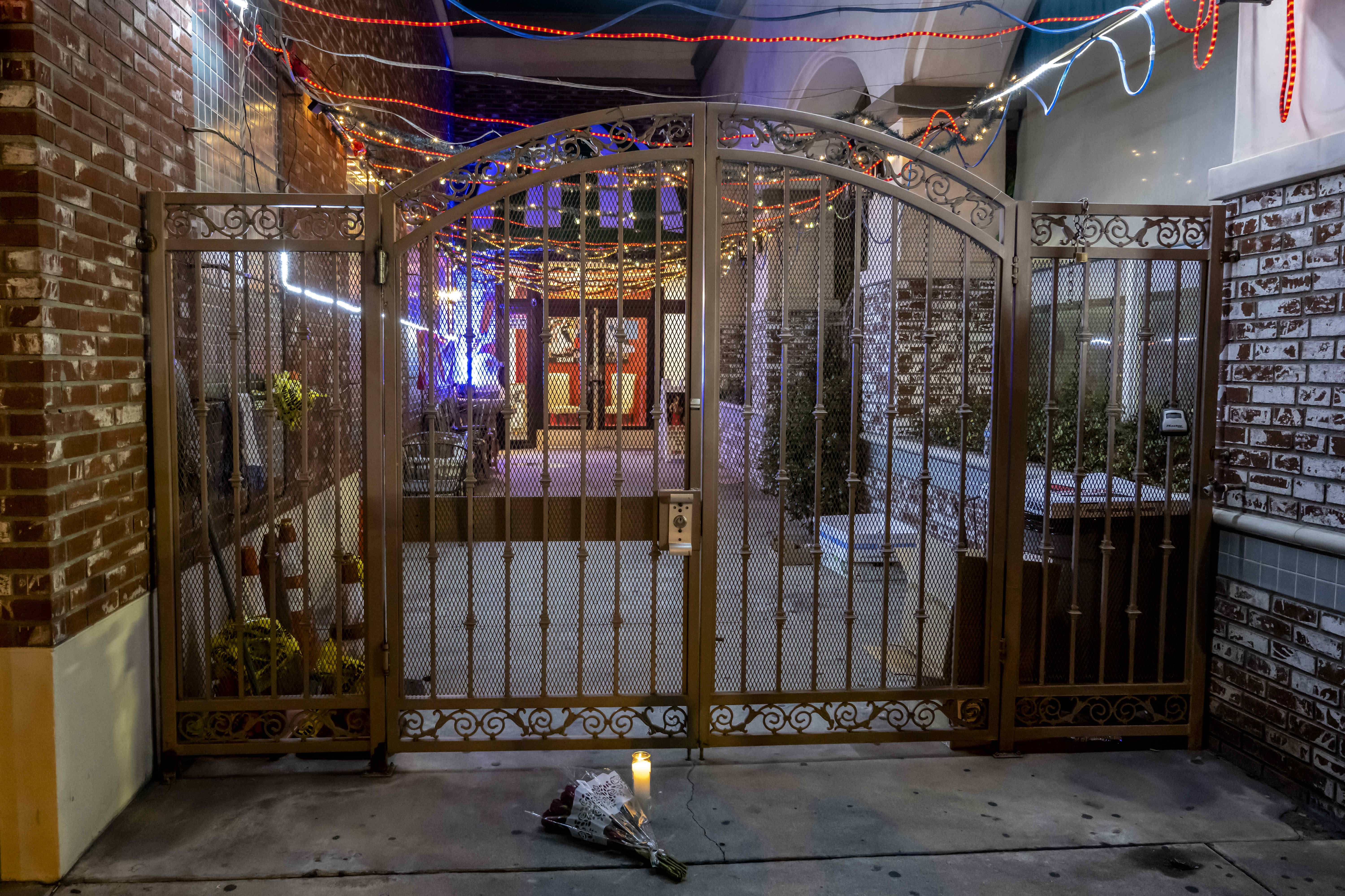  Flowers and a candle were placed at the entrance to the Star Ballroom Dance Studio after police took down the crime scene tape in Monterey Park on Sunday, January 22.
