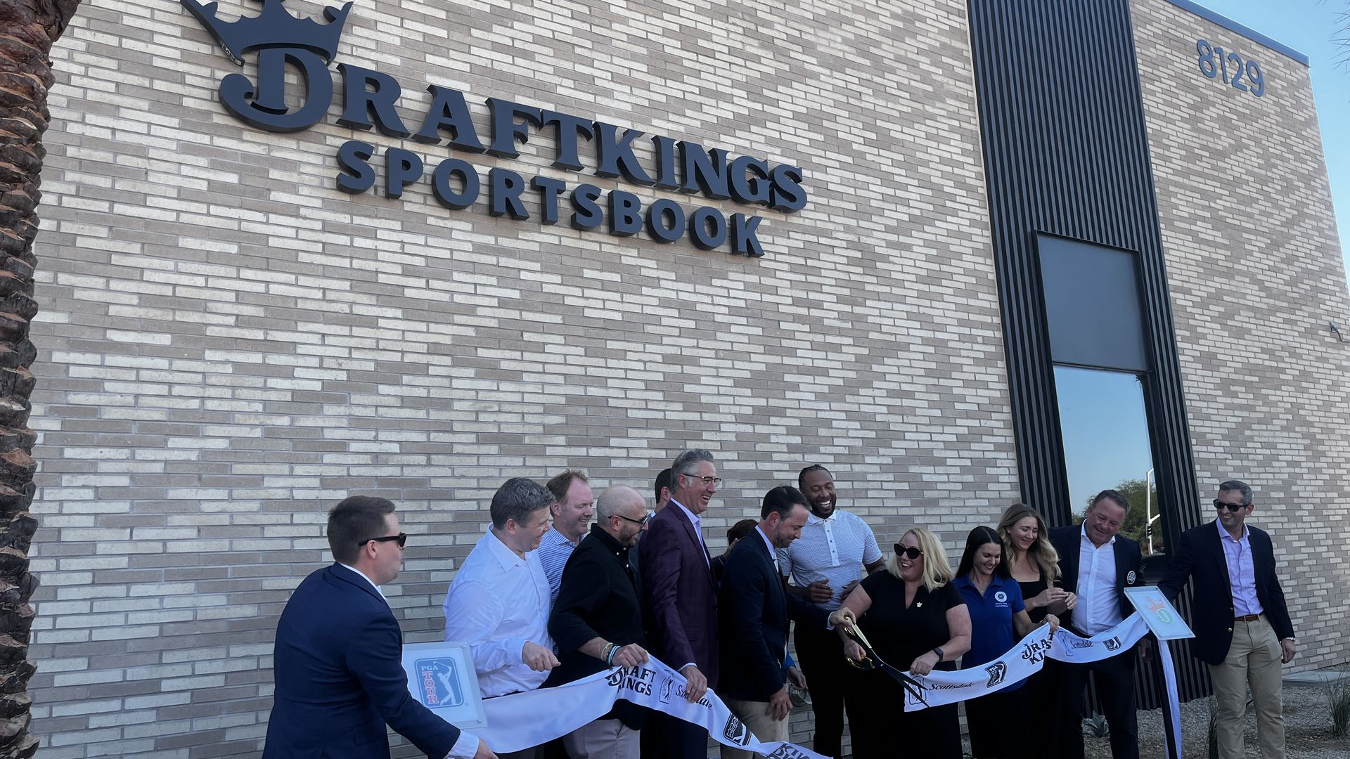 People cutting a ribbon.