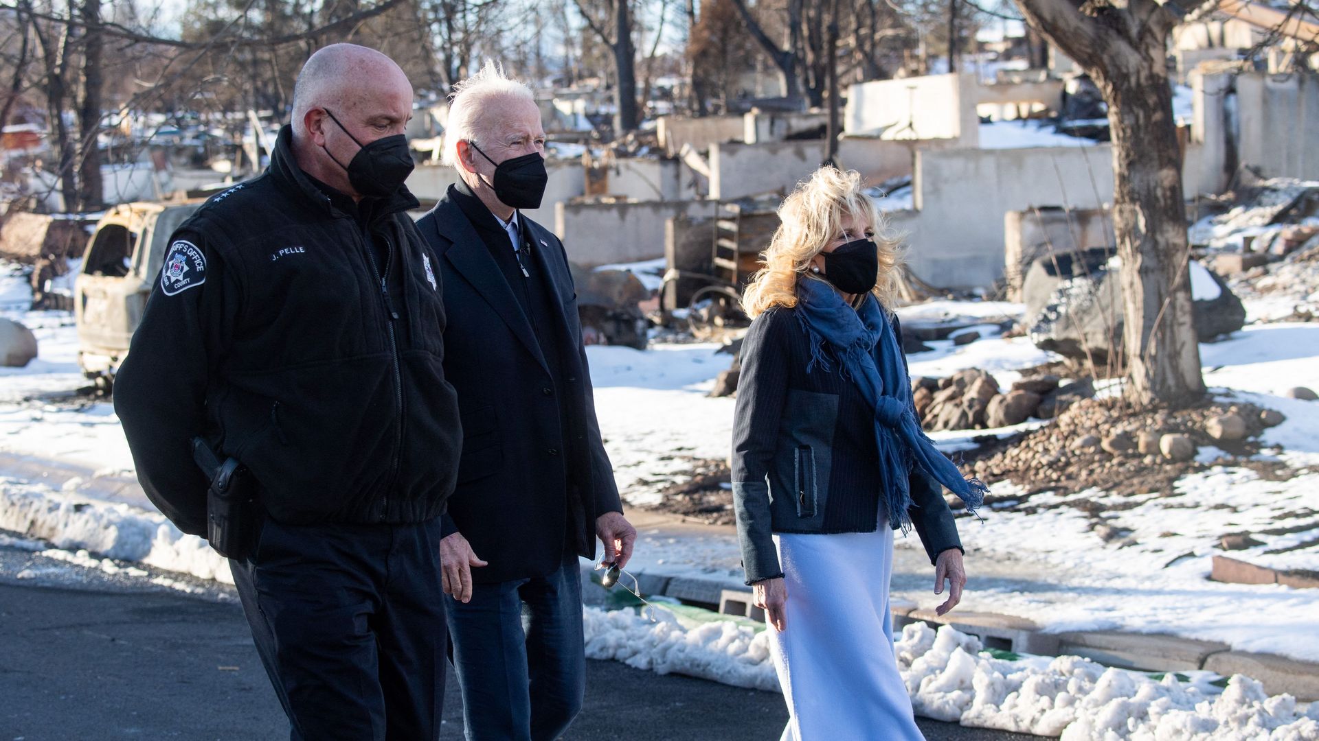 President Biden and First Lady Jill Biden tour a Louisville neighborhood destroyed by the Marshall Fire alongside Boulder County Sheriff Joe Pelle on Friday. Photo: Saul Loeb/AFP via Getty Images