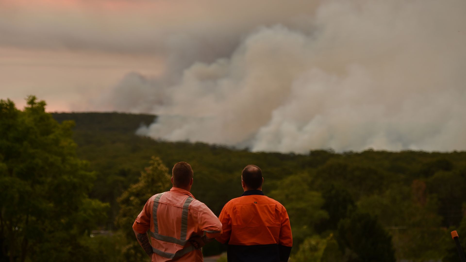 Firefighters watching a large bushfire burn from Bargo, Australia, in December 2019.