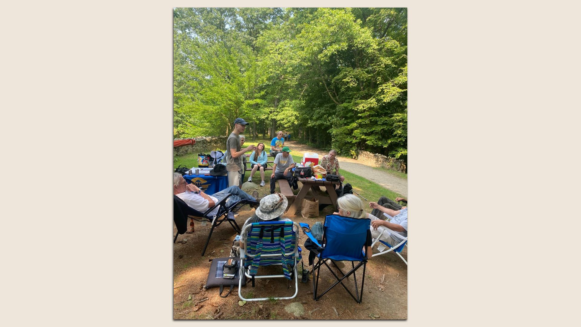 A group of medical cannabis patients sit on fabric lawn chairs at a Massachusetts park.