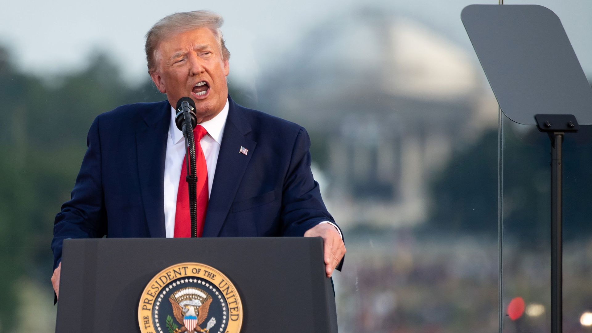 President Donald Trump speaks at a podium during a Fourth of July event