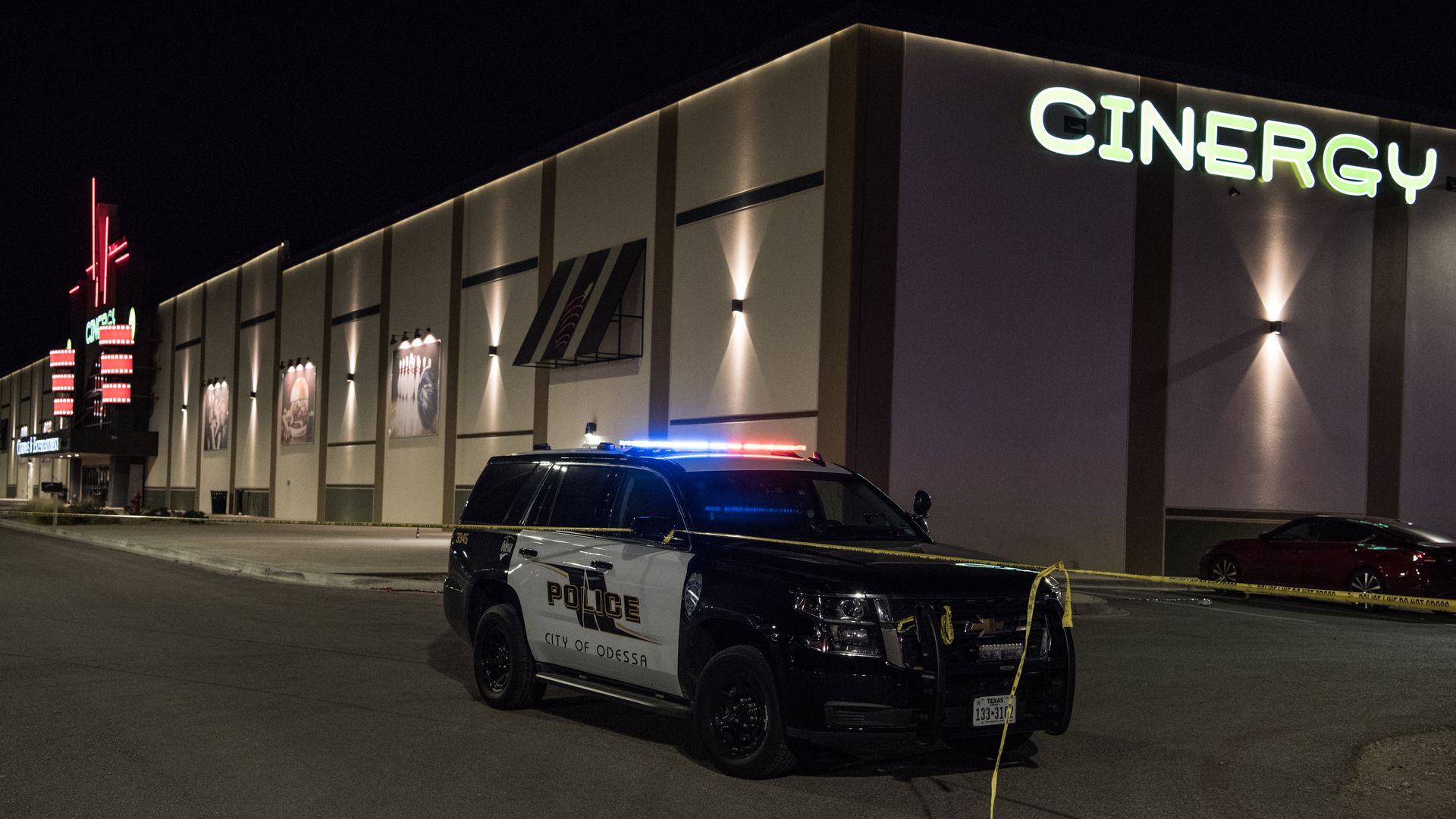  Police cars and tape block off a crime scene nearby to where a gunman was shot and killed at Cinergy Odessa movie theater 