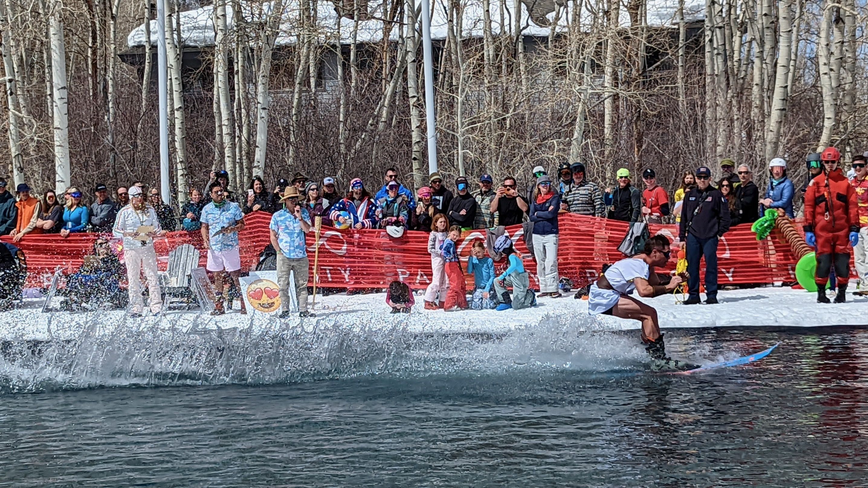 A man dressed as Spartacus skis across the water.