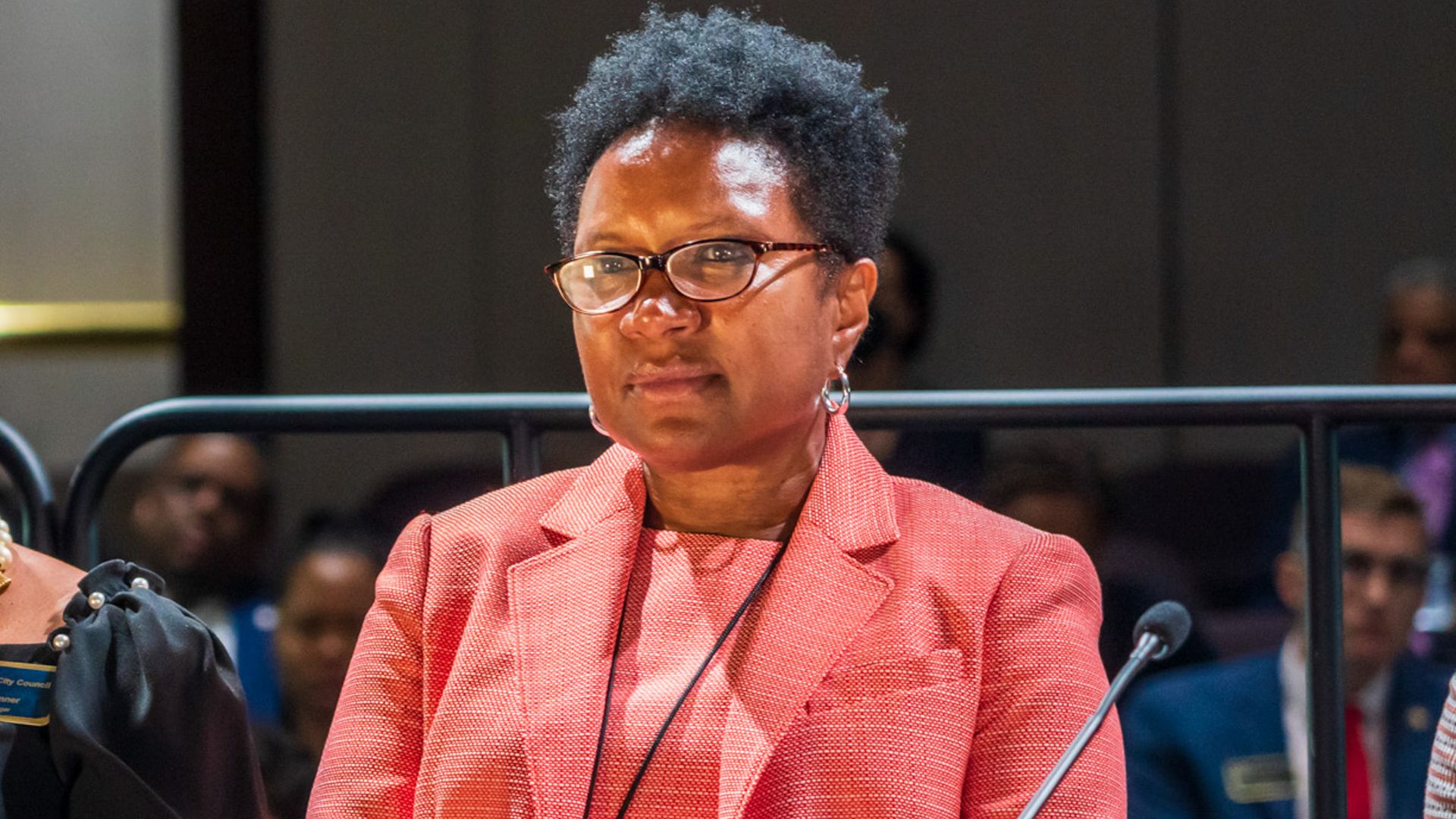 Corrine A. Lindo seated in front of the Atlanta City Council in the council chambers.
