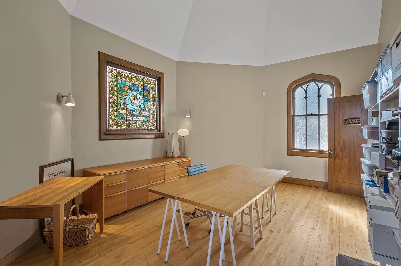 An office with tan walls and stained glass windows.