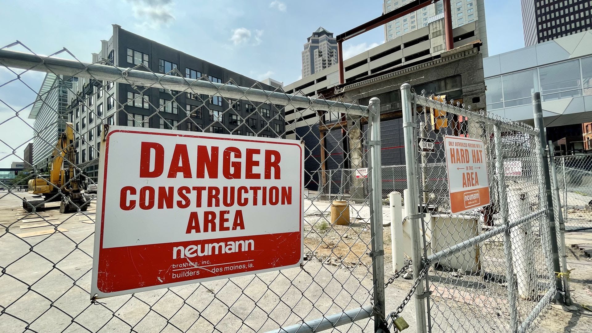 A warning sign on a fence outside the downtown Des Moines construction site where EMC Insurance wants to build a park.