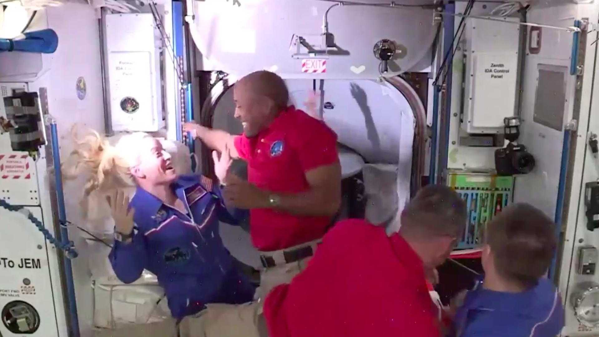 NASA astronauts Victor Glover and Kate Rubins hug as Glover comes aboard from his SpaceX Crew Dragon capsule